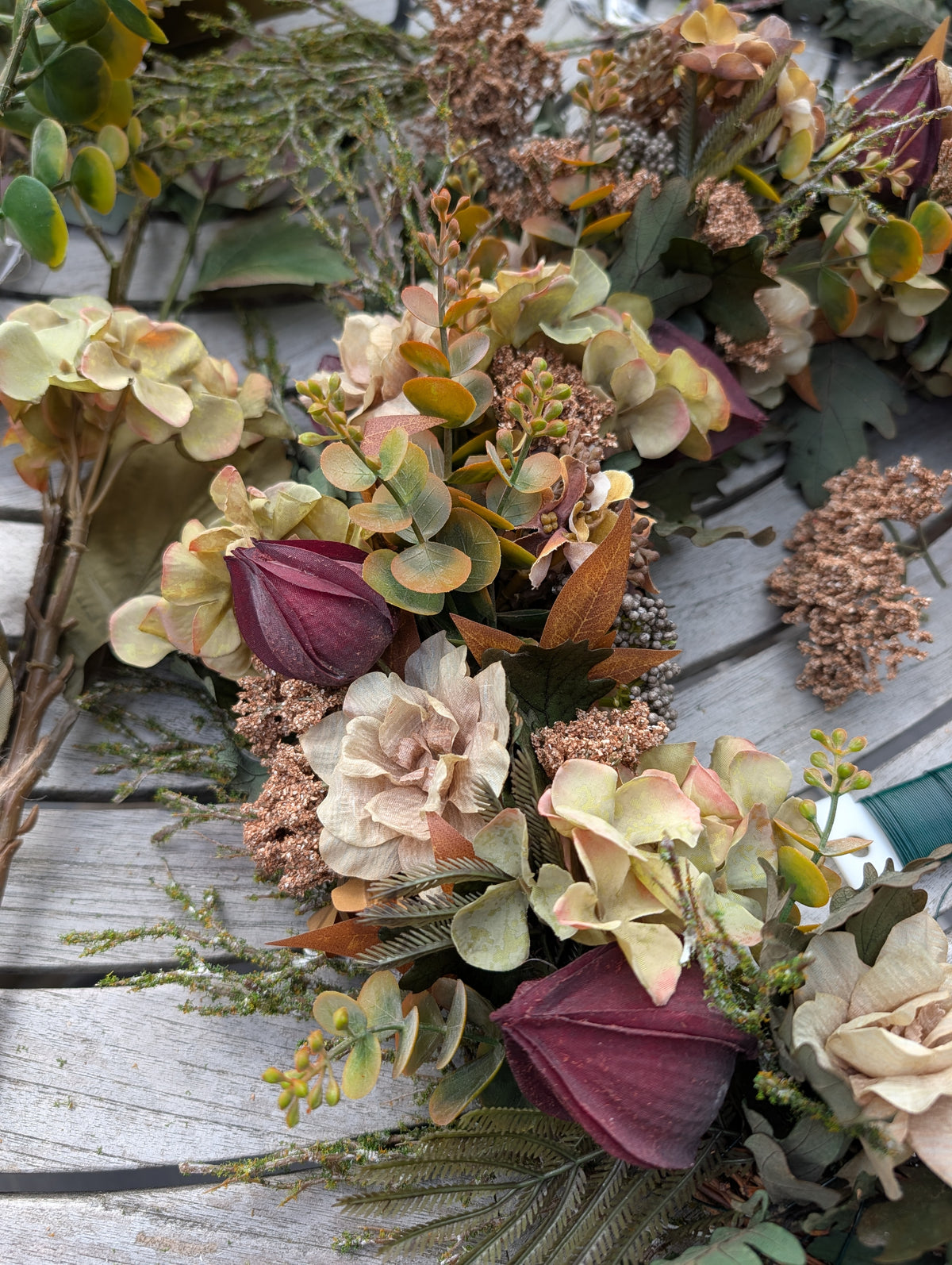 Close up on seasonal hydrangea wreath being made